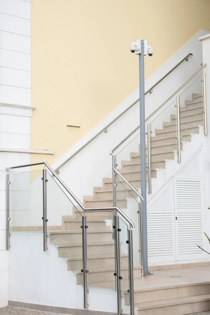 Escada com guarda-corpo de vidro e corrimão de inox
